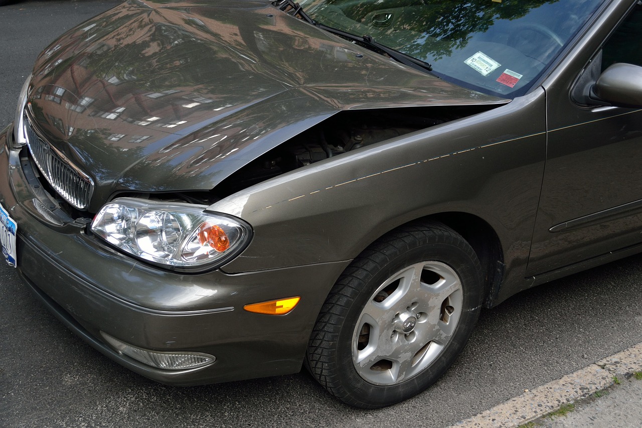 Valet parking mishap: Luxury sedan with crumpled fender
