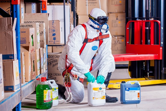 A pest exterminator in a white jumpsuit and respirator mask
