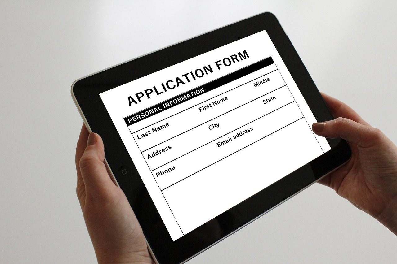 Property manager enters new tenant details on a tablet.