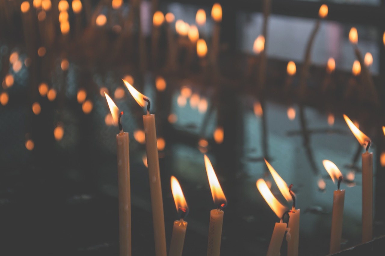 Soft glow of lit candles at a house of worship.