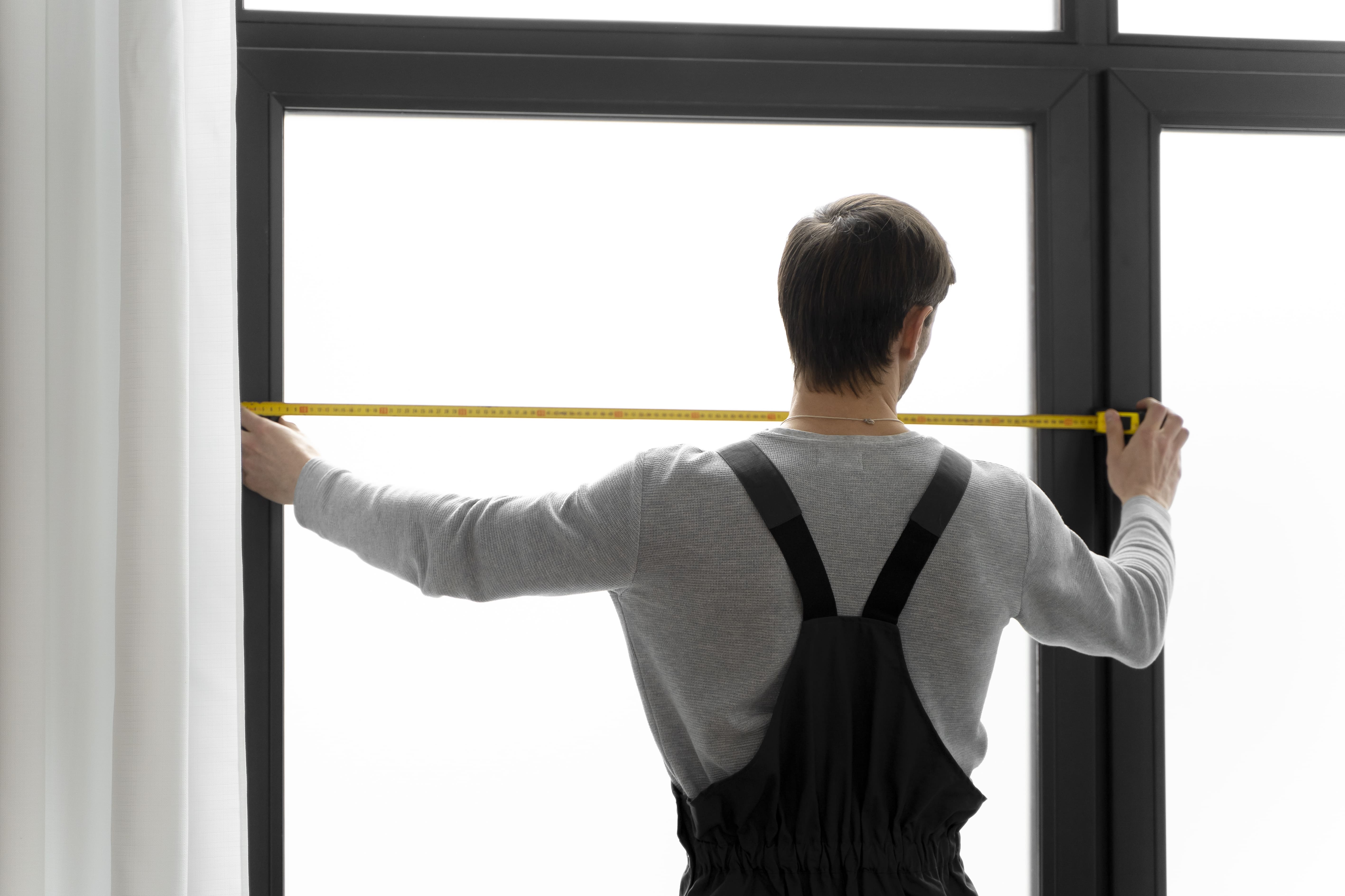 A Glazier Worker Taking Measurements